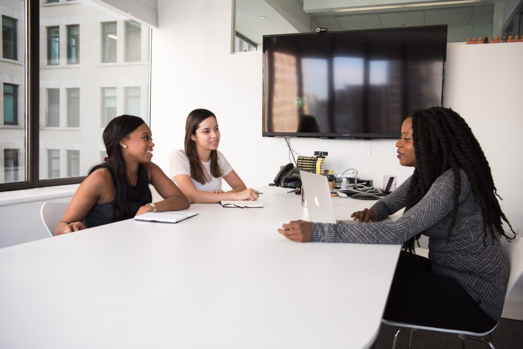 Competency management - women talking at a table
